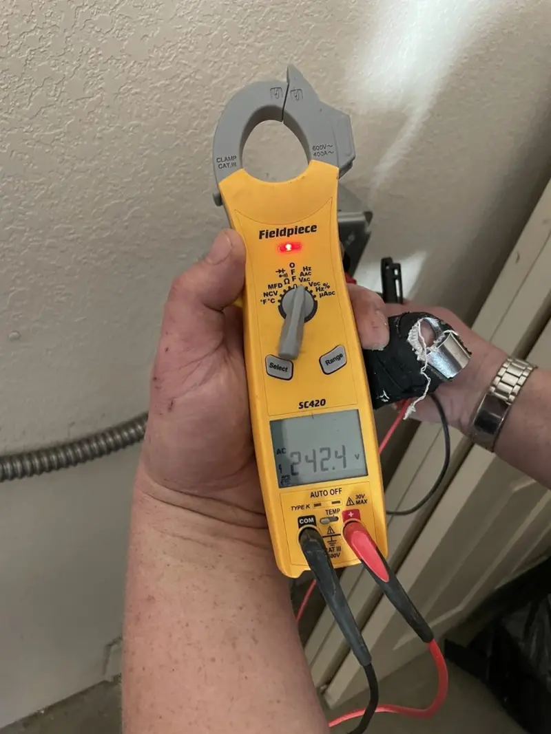 Voltage testing with clamp meter during Electrical Installation Services in Burlington